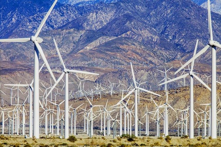 The Hottest City in Every State - Infographics of a Wind turbines in an arid desert landscape, highlighting renewable energy efforts in heat-prone regions like Southern California