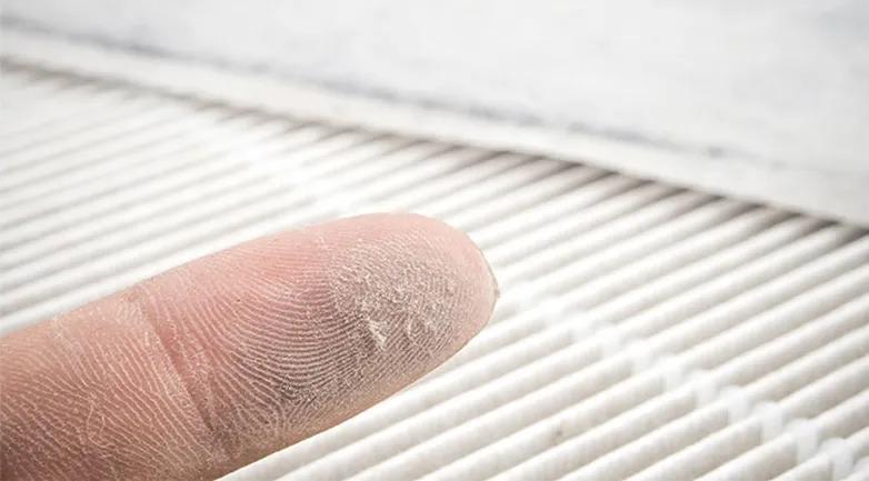 How Often Do I Really Need to Change My HVAC Filter - View of a dusty finger after checking a dirty air filter.