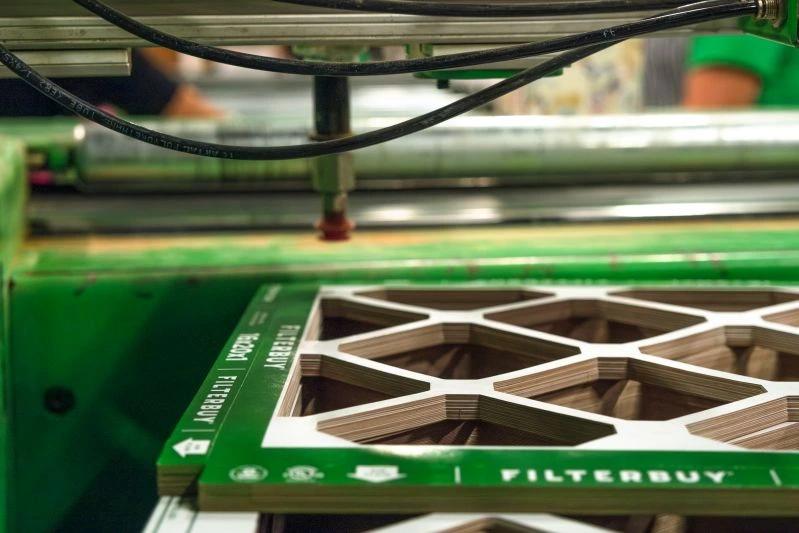 View of close-up view of Filterbuy air filters being assembled on a green production line.