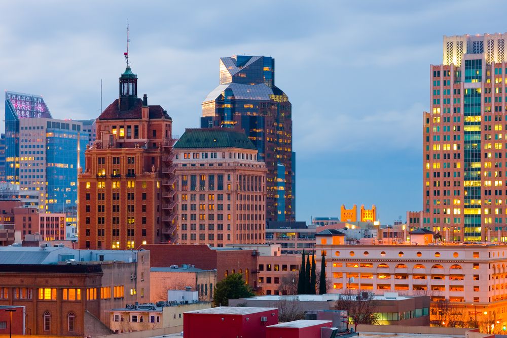 Sacramento skyline at dusk with a mix of historic and modern architecture.