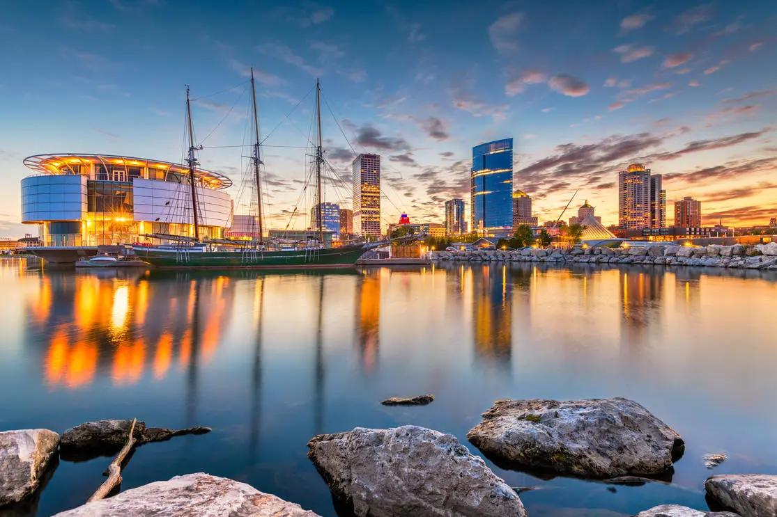 View of Milwaukee downtown with the arena just beside the waterway.