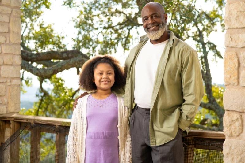 Air Filter Media Material Replacement for Home - An image of a father and a daughter smiling at each other, captured in the lobby.