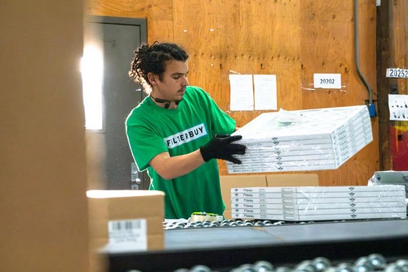 view of a man working inside the filterbuy company