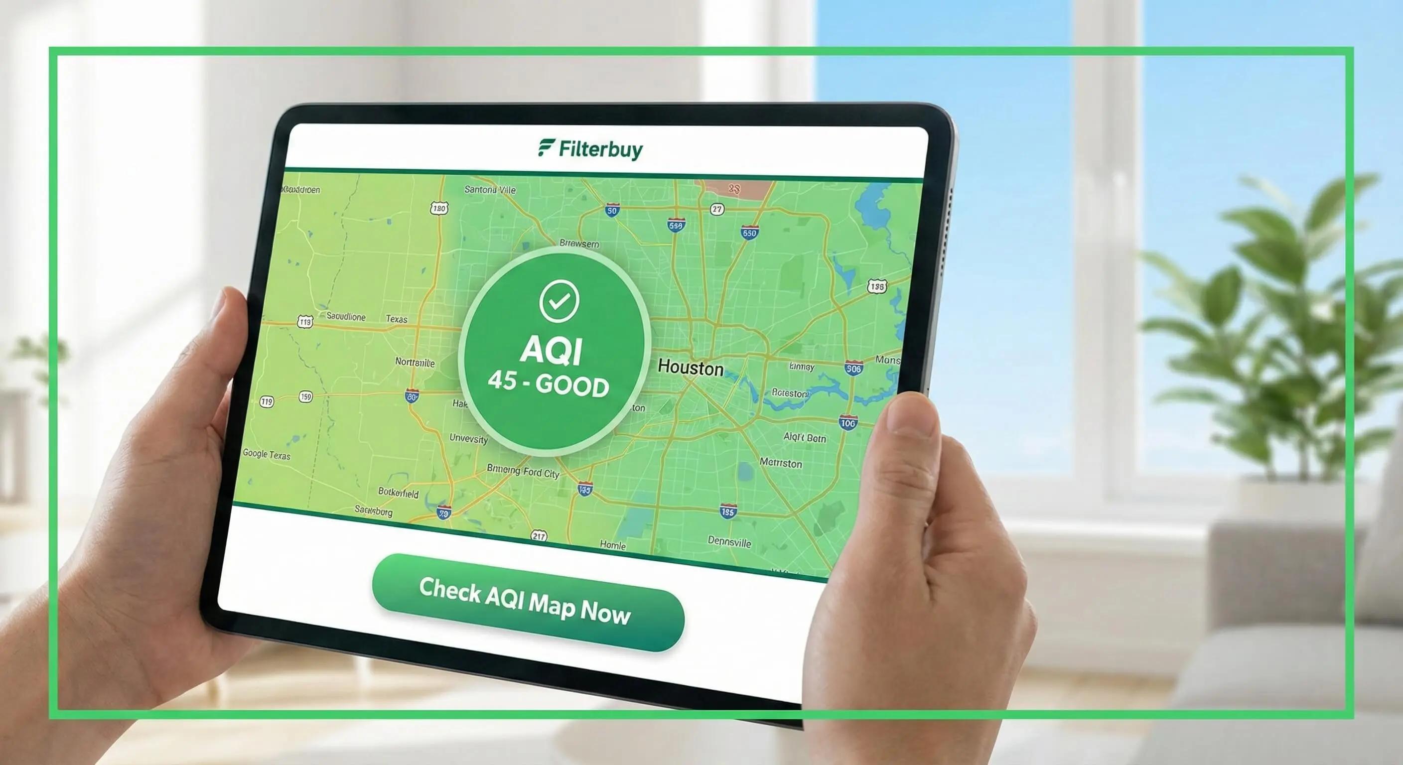 Person holding a tablet displaying the Filterbuy AQI map for Houston, Texas, showing a 'Good' air quality reading of 45.