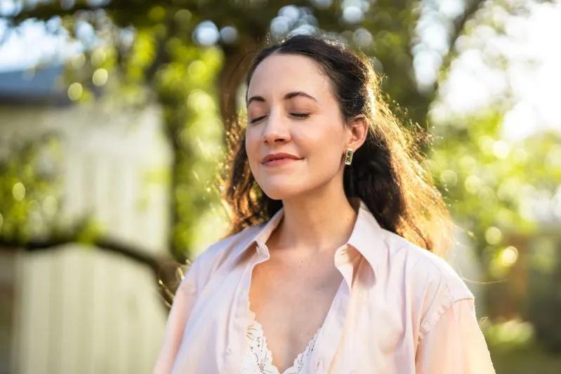 A view of a relaxed woman in a cozy home environment, breathing comfortably due to the advanced performance of a 12x22x1 air filter.