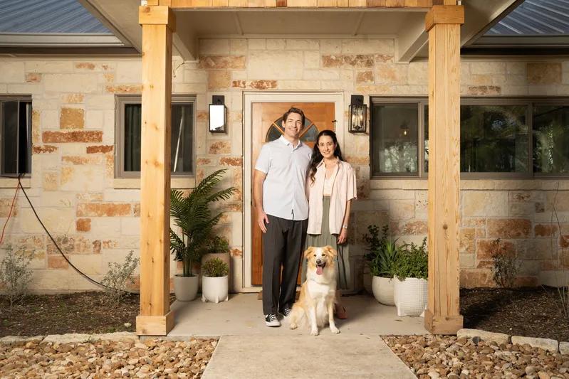 View of a happy couple with their dog in front of their home, highlighting the comfort and protection provided by the best 20x22x4 air filters for allergens.