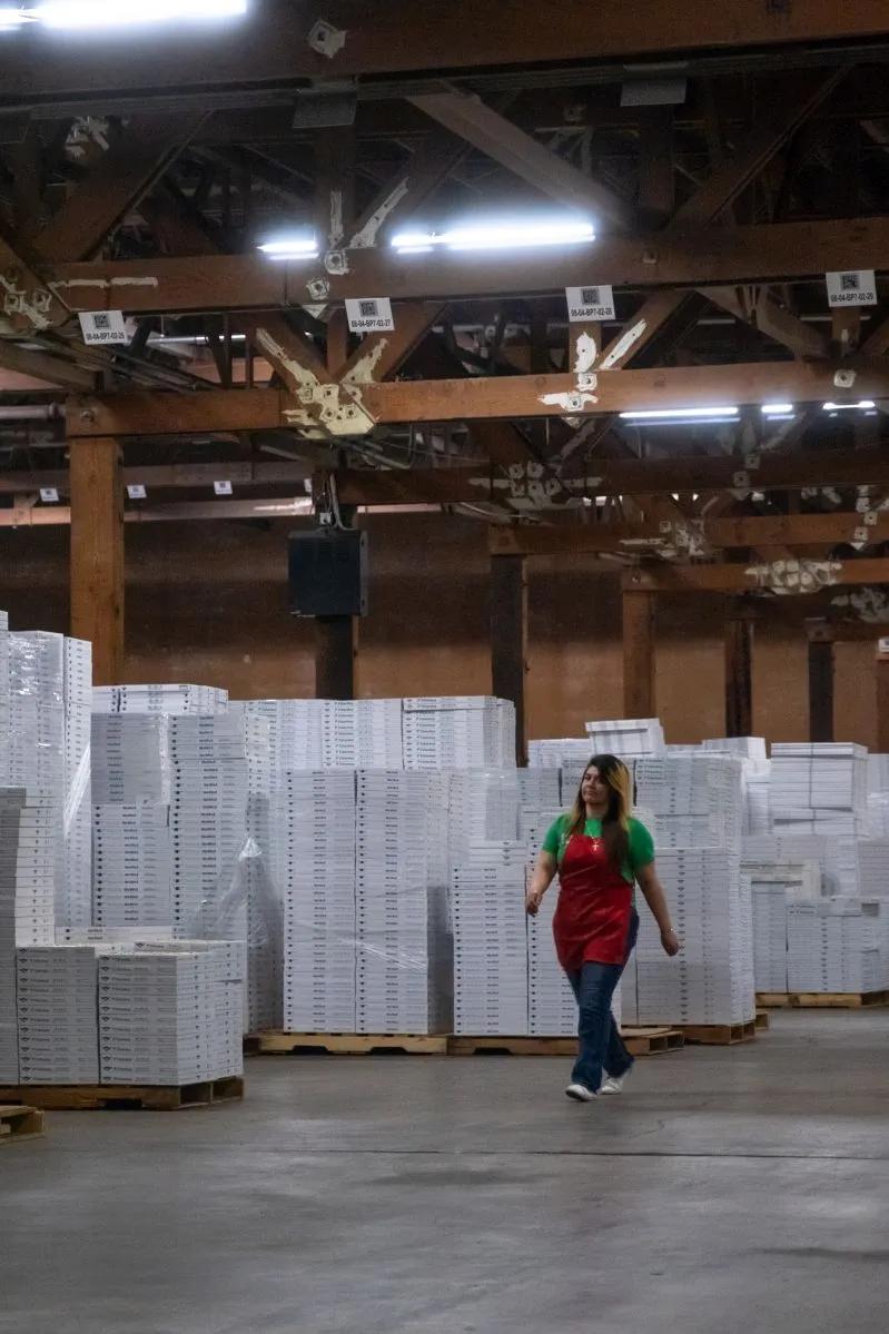 13x24x2 HEPA Air Conditioner Filter Near Me - View of a female employee of Filterbuy walking inside the company facility