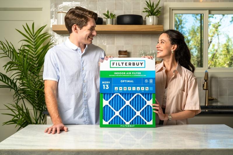 Best Idylis Air Purifier Replacement Air Filters - Image of a couple smiling and holding a Filterbuy Indoor Air Filter, showing the MERV 13 rating.