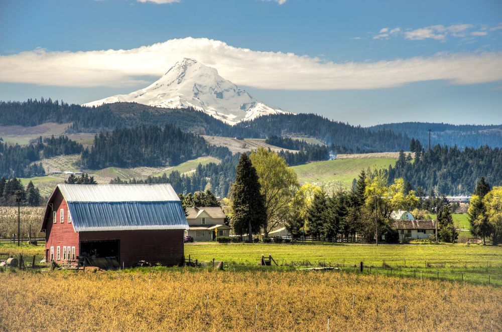 Rural Oregon with a barn and mountain, representing areas where Korean War veterans may live.