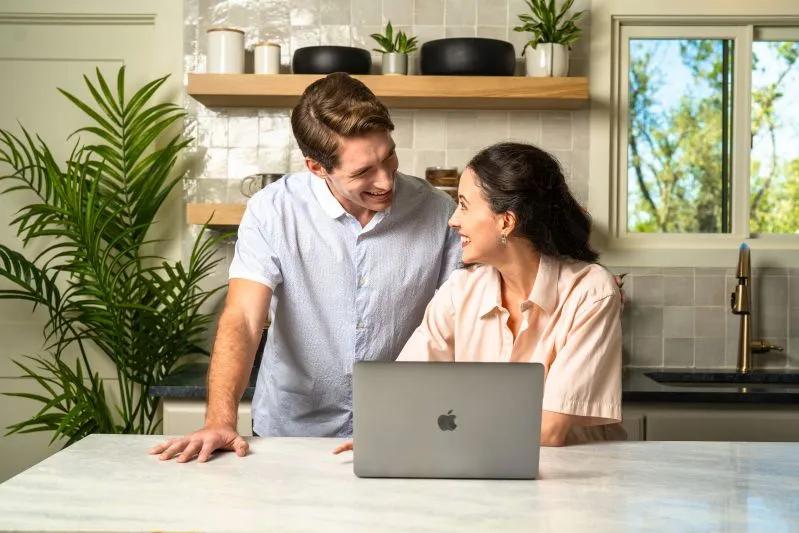 Buy a High-Quality 10x15x4 Air Filter for Your Air Conditioner - View of a happy couple researching online to buy a high-quality 10x15x4 air filter for their air conditioner to reduce airborne contaminants and boost HVAC efficiency.