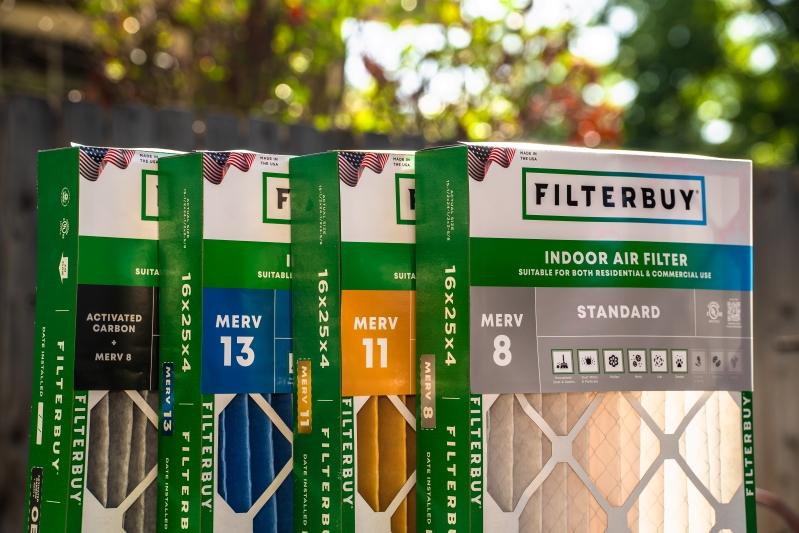 Enhance Your Home’s Air Quality with Scented HVAC Air Filters - Image of Filterbuy indoor air filters displayed outdoors, including MERV 8, 11, and 13 with activated carbon, showcasing various air filtration options.