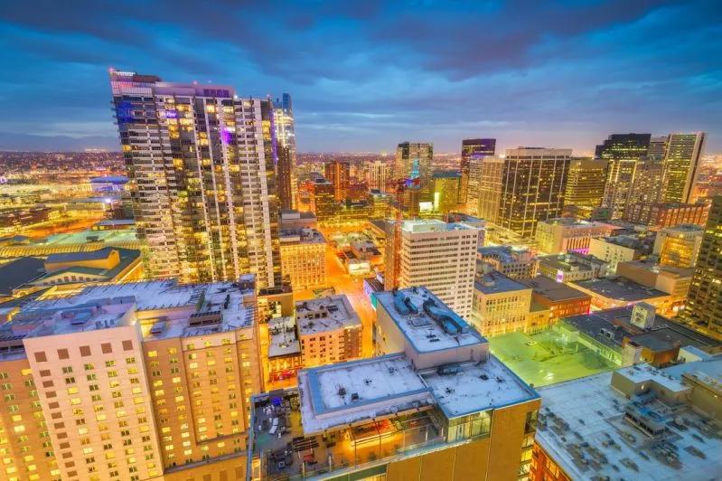 "View of downtown Denver lit up at dusk, highlighting its status as a top remote work-ready city.