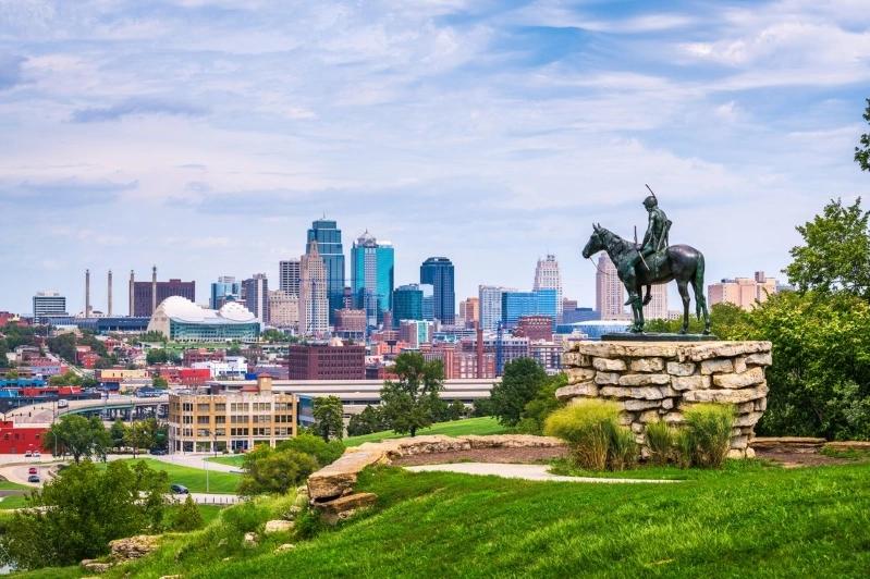 Cities Where Remote Workers Log the Most Hours - Images of a the Kansas City skyline with a statue of a mounted soldier, highlighting the city's downtown and green landscape.