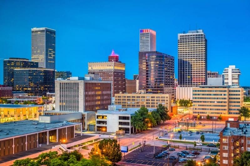 Cities with the Most Asthma Cases - Image of Tulsa city skyline with  modern skyscrapers, and city streets under a colorful sky at dusk.