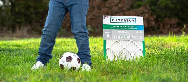 View of man beside an air filter outdoors