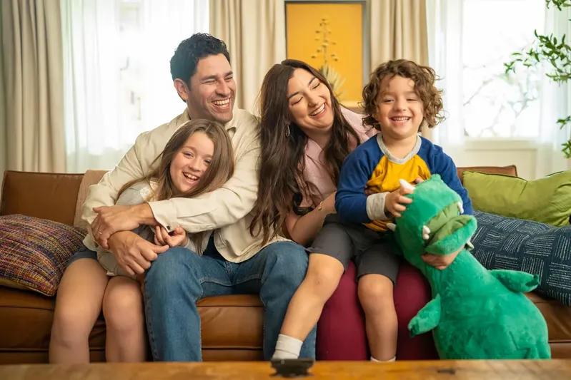 A view of a joyful family relaxing on a couch, reflecting the comfort and health benefits of better air quality provided by 18x24x4 air filters in the home.