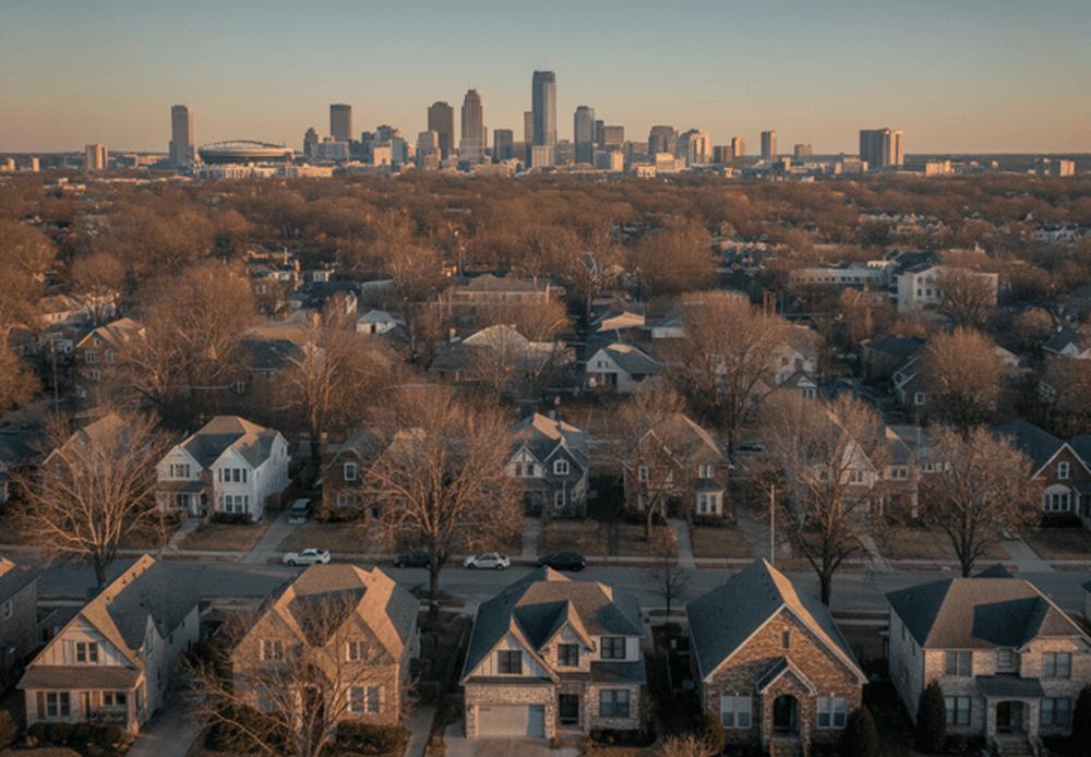 An image of suburban Indianapolis homes with a clear view of the downtown skyline at sunset.