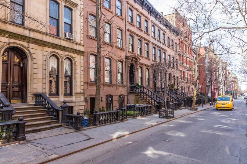 Street view of brownstone homes in New York City, where residents face some of the nation’s highest utility costs.