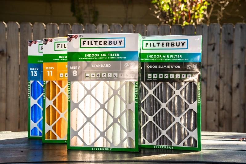 Where to Buy Vacuum Cleaner Replacement Air Filters Near Me - Image of various Filterbuy air filters with different MERV ratings (8, 11, 13) and an odor eliminator filter on display outdoors.