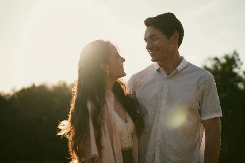 Best Activated Carbon Treatment Filters for Home - Image of a young couple smiling at each other outdoors against a sunset setting.