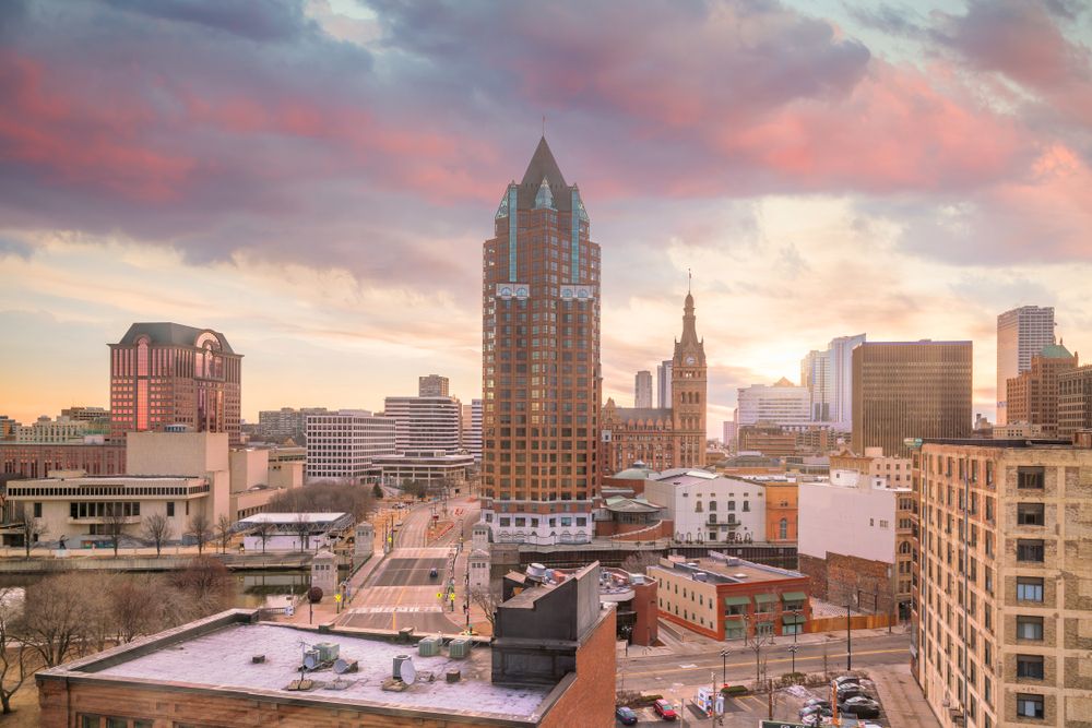 Milwaukee skyline at sunrise with vibrant sky.