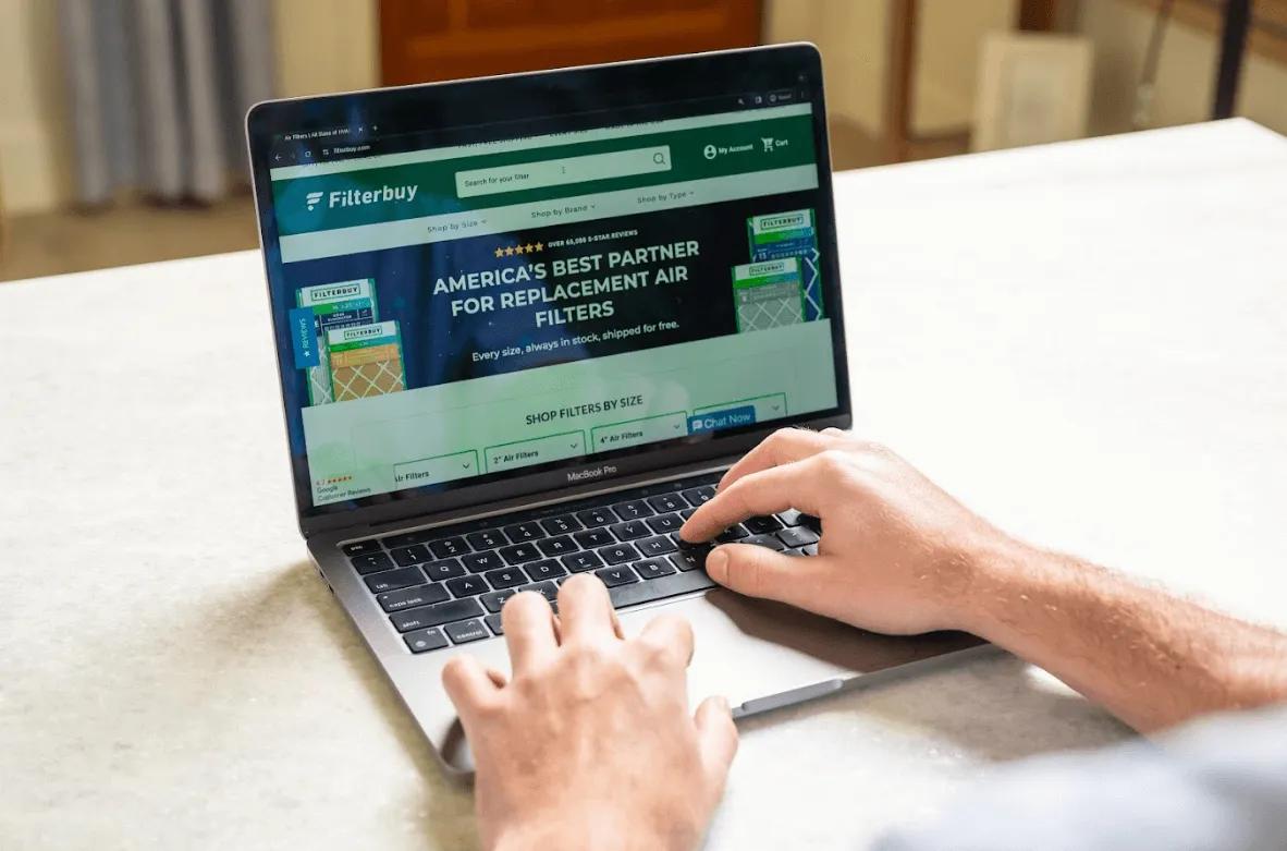 Image of Person browsing Filterbuy’s website for top-rated pocket air filters to improve indoor air quality and reduce allergens at home.