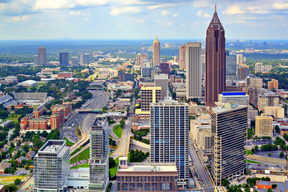 Aerial view of a downtown area with tall buildings and busy highways on a clear day