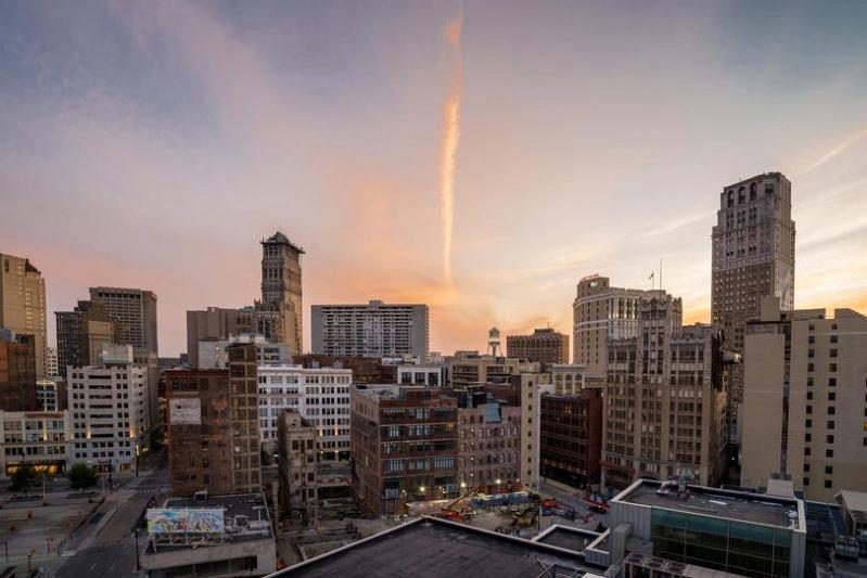 Cities with the Most Asthma Cases - Image of the city downtown in Detroit, with modern office buildings and a blue sky.