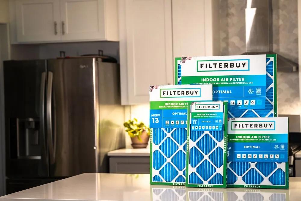  A view of Filterbuy indoor air filters displayed in a modern kitchen, featuring various sizes and MERV 13 options for optimal HVAC performance. Image