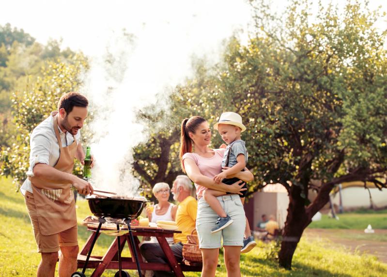 View of family having picnic outdoors