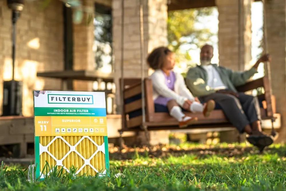 A view of a 17x20x4 HVAC air filter on a lawn with a family relaxing nearby, highlighting the best home air filters for comfort and cleaner indoor air.