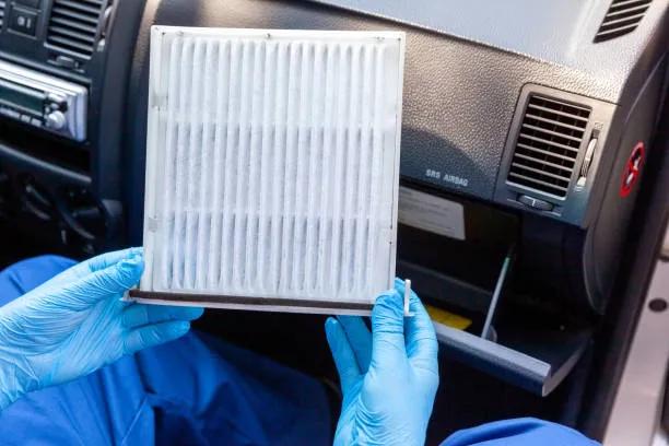 A view of a technician holding a vehicle cabin air filter
