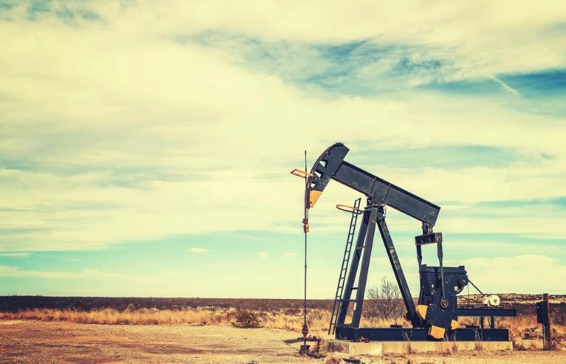 States With Fastest Growing Economies - Vintage-toned image of an oil pump jack in Texas.