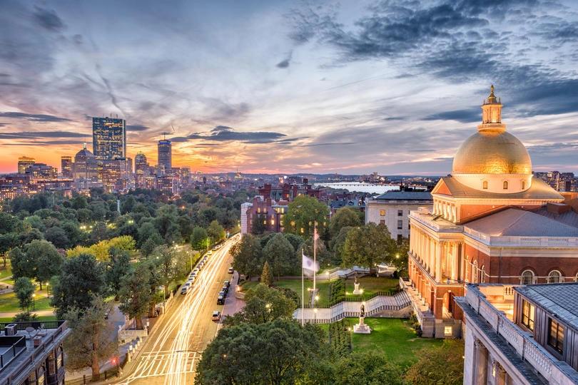 Boston skyline and State House at sunset, highlighting one of the top cities for high monthly utility bills in the U.S.