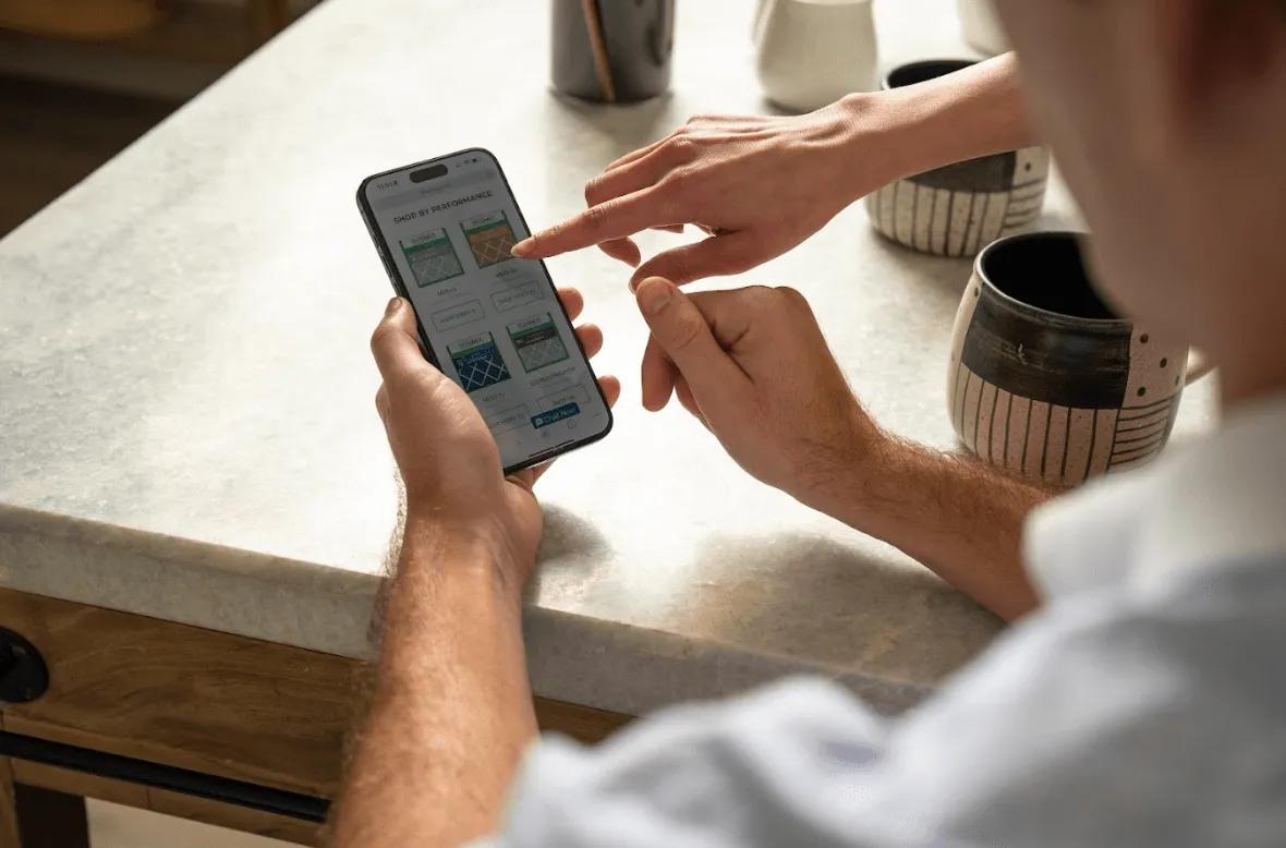 Image of a person shopping pleated ring panel air filter replacements on Filterbuy.com via smartphone