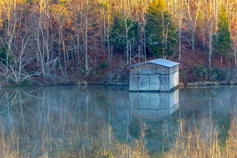 The Hottest City in Every State - Infographics of rural lakeside view of boathouse surrounded by autumn forest