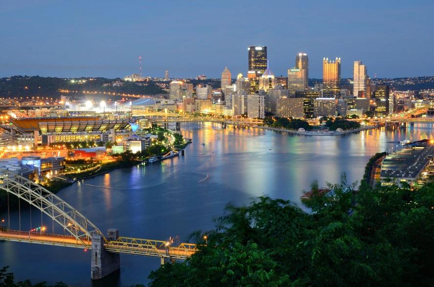 Pittsburgh skyline at night, one of the U.S. cities with high utility costs impacting housing budgets.