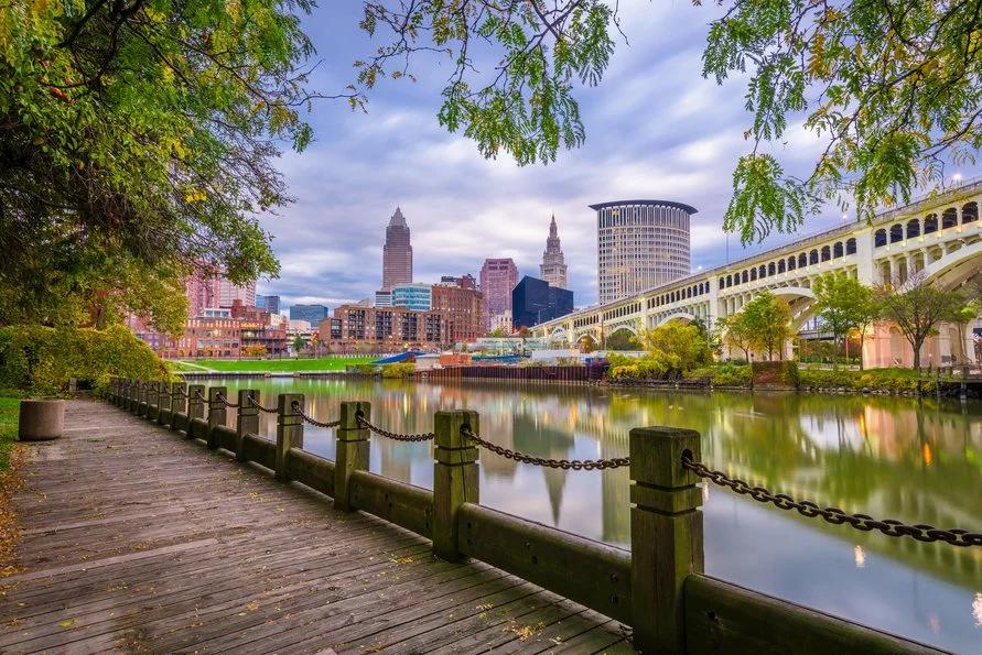Image of Cleveland, Ohio's downtown on a cloudy day as seen beside the wooden viewdeck beside the river. 