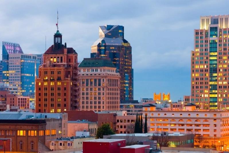 Cities with the Most Asthma Cases - Image of Sacramento skyline with modern glass buildings during sunset.