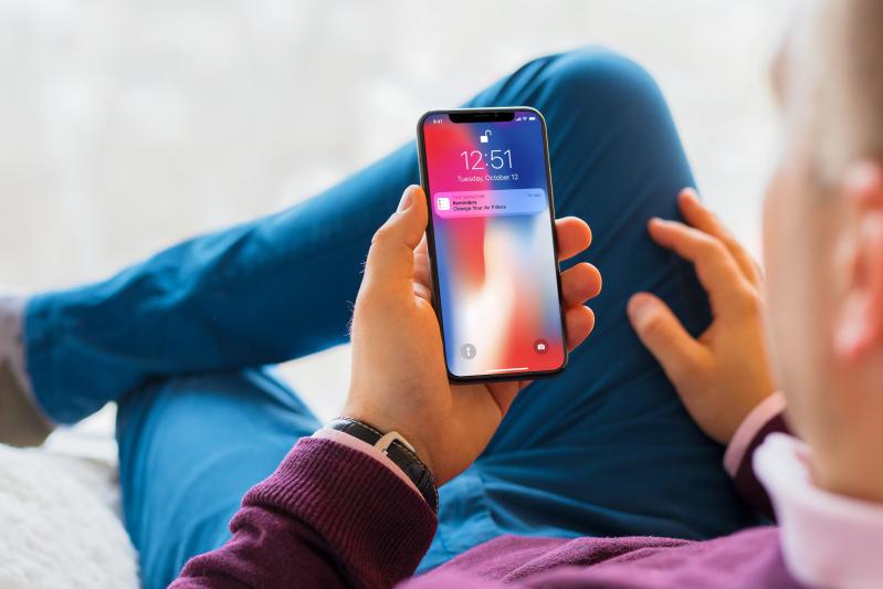 Best 21.25x21.25x2 Air Filter for Allergies - View of man holding a smartphone with a note to change air filters