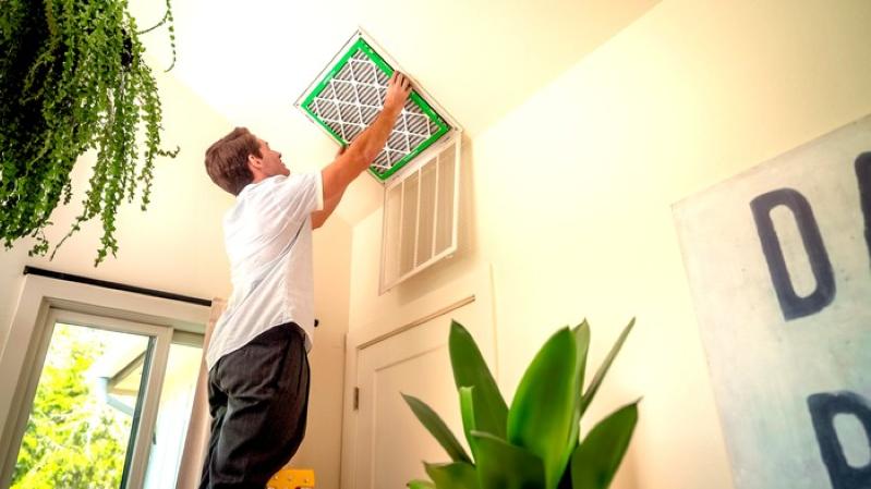A view of a professional technician installing a new air filter.