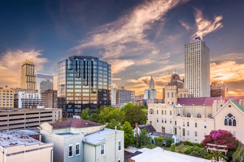 Cities With the Most Multigenerational Households - Image of Memphis skyline with modern glass buildings and historic structures during sunset, showcasing a blend of old and new architecture.
