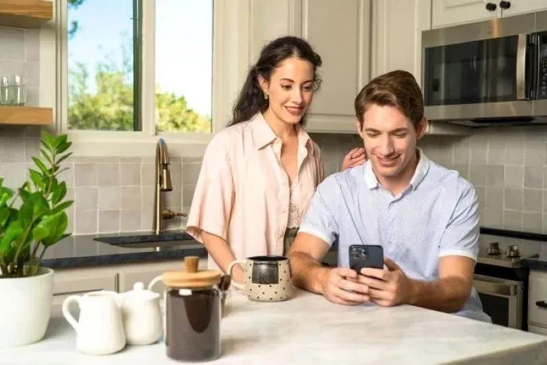 A view of a couple researching the most effective 8x16x1 air conditioner filters for allergy relief at home.