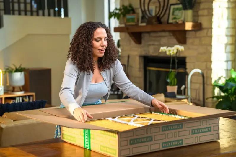 Air Purifier Filter Replacement Cost & Frequency - Image of a woman unboxing her order.