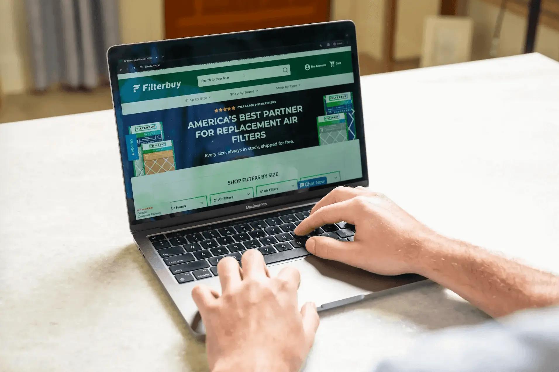 Image of a person browsing the Filterbuy website on a laptop to shop for HVAC air filters.