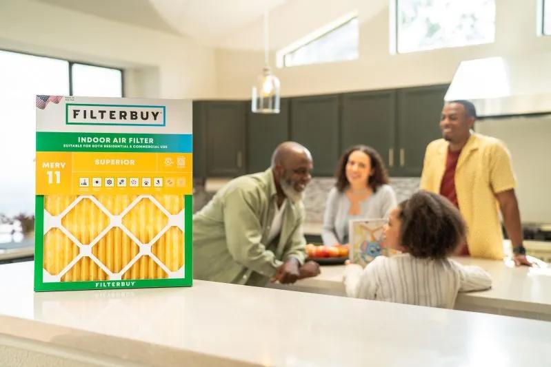 View of a family enjoying time together in modern kitchen with Filterbuy indoor air filter in the foreground