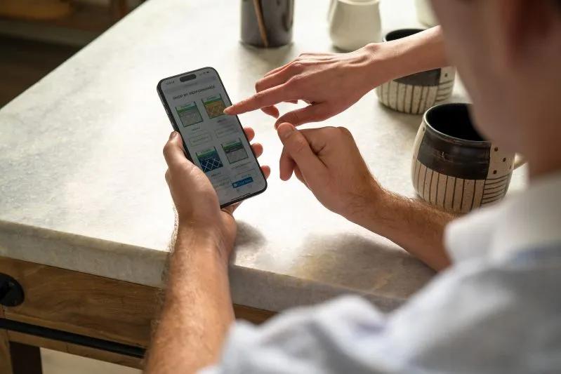 View of man using a mobile phone to browse selections of Filterbuy air filters