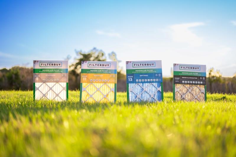 Image of various Filterbuy air filters with different MERV ratings displayed on grass outdoors, showing options for indoor air quality.