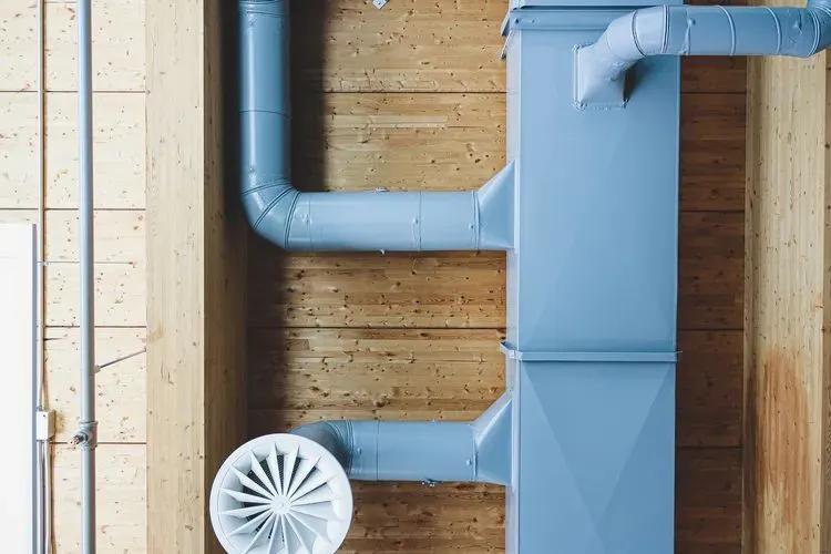 Image of an exposed HVAC duct system mounted on a wooden wall, showcasing modern ventilation and air circulation design.